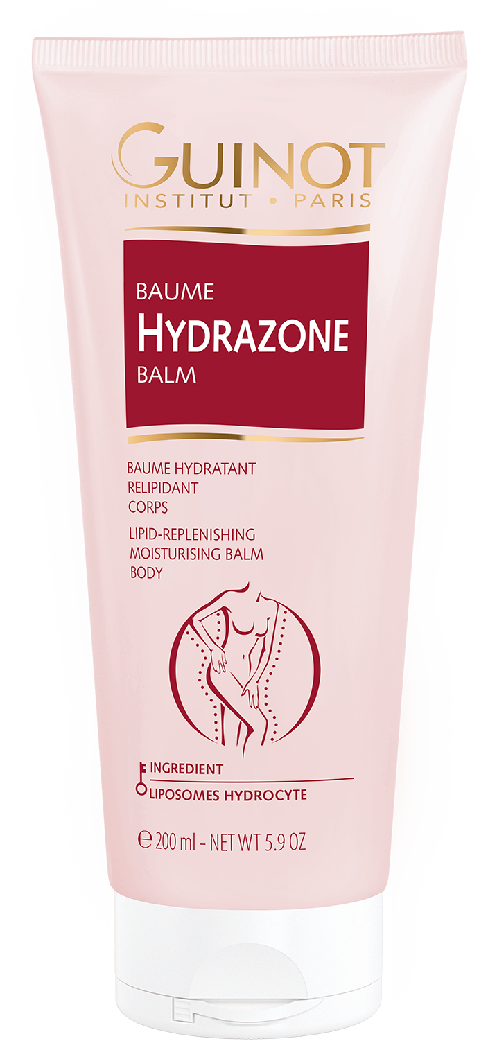 A tube of GUINOT Hydrazone Balm with pink and white packaging, highlighting its benefits for sensitive skin, collagen, elastin, hyaluronic acid, vitamin E, and magnesium.
