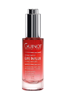 A bottle of Guinot Life Influx Concentrate, a regenerating anti-aging serum in a red pump bottle with silver lid